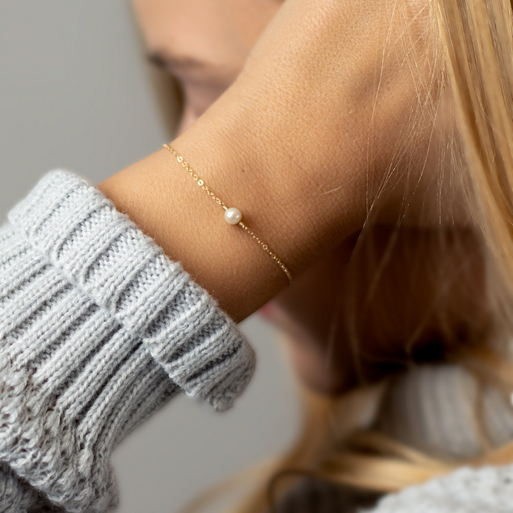 a close up of a person wearing a bracelet