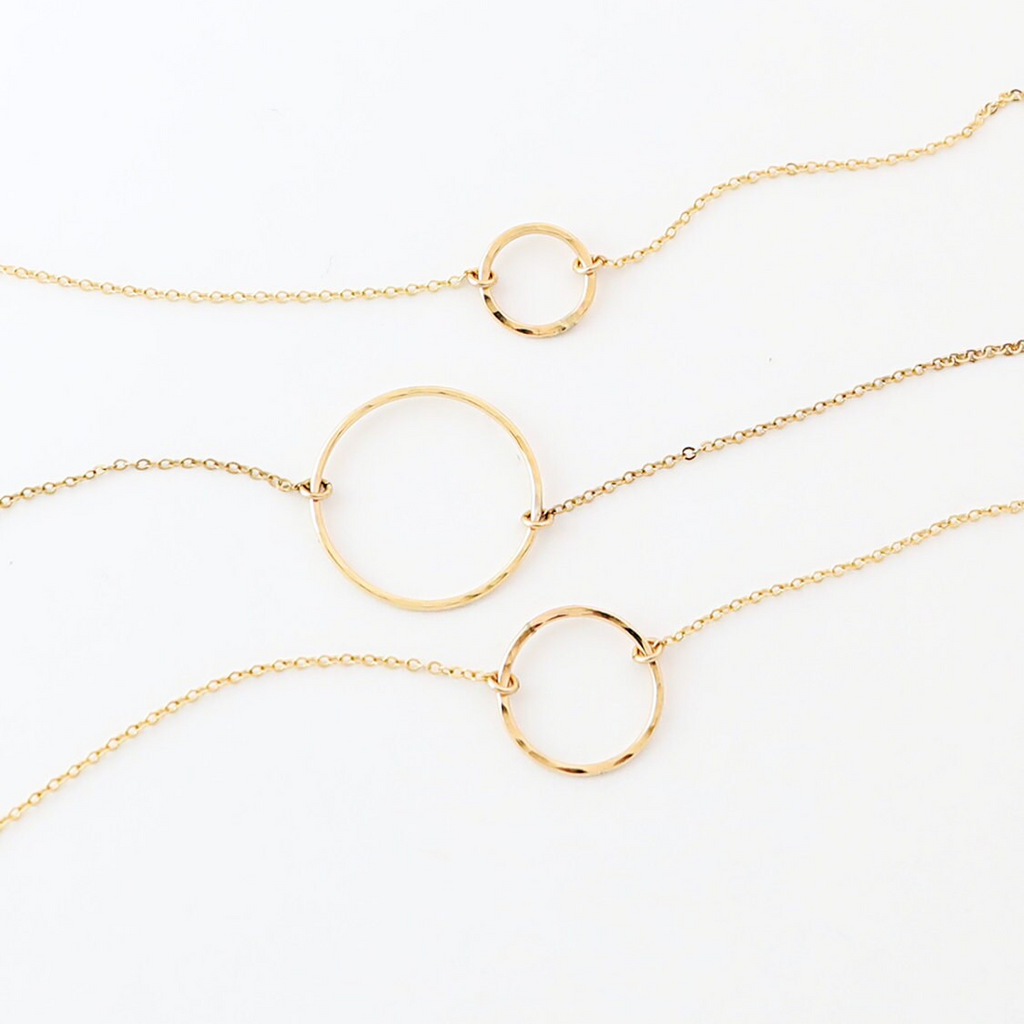 three gold circles on a gold chain
