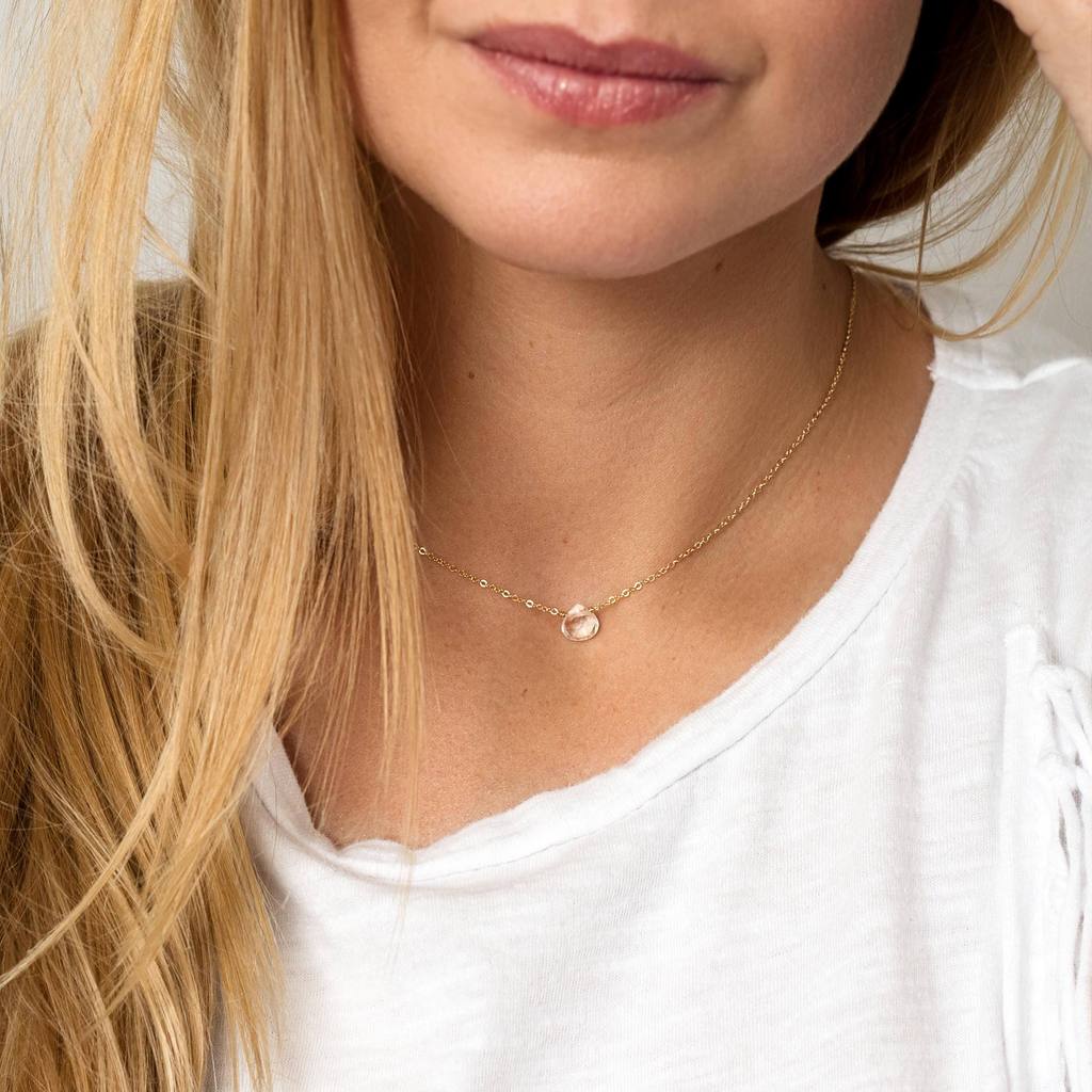 a close up of a person wearing a necklace