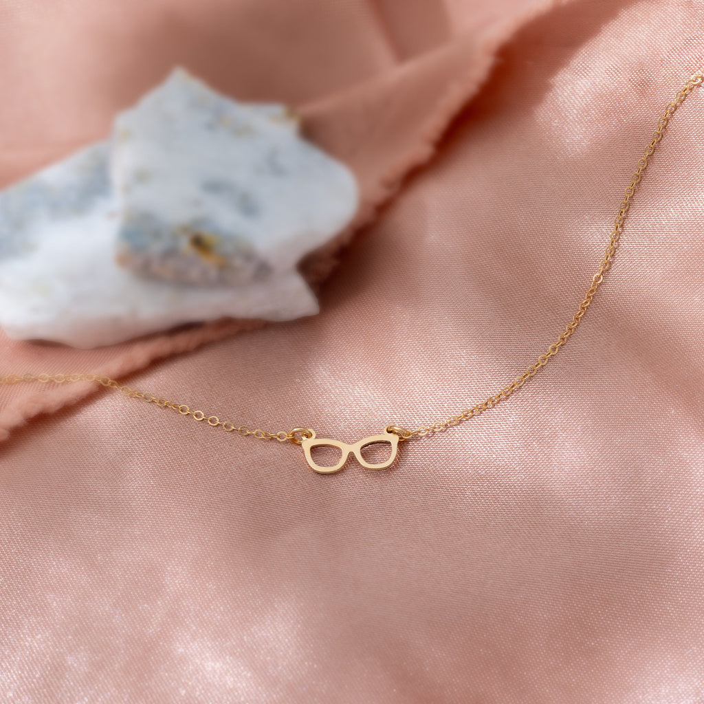 a close up of a necklace on a pink cloth
