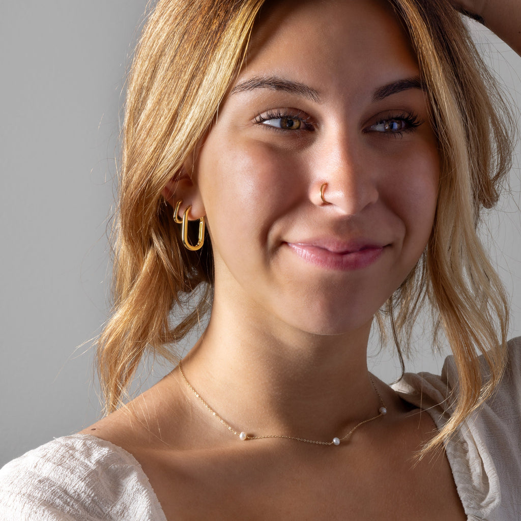 a close up of a person wearing a necklace
