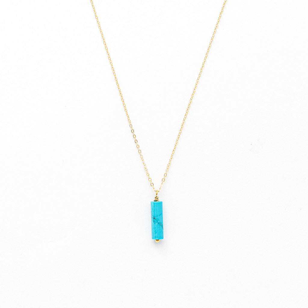 a gold necklace with a turquoise stone pendant