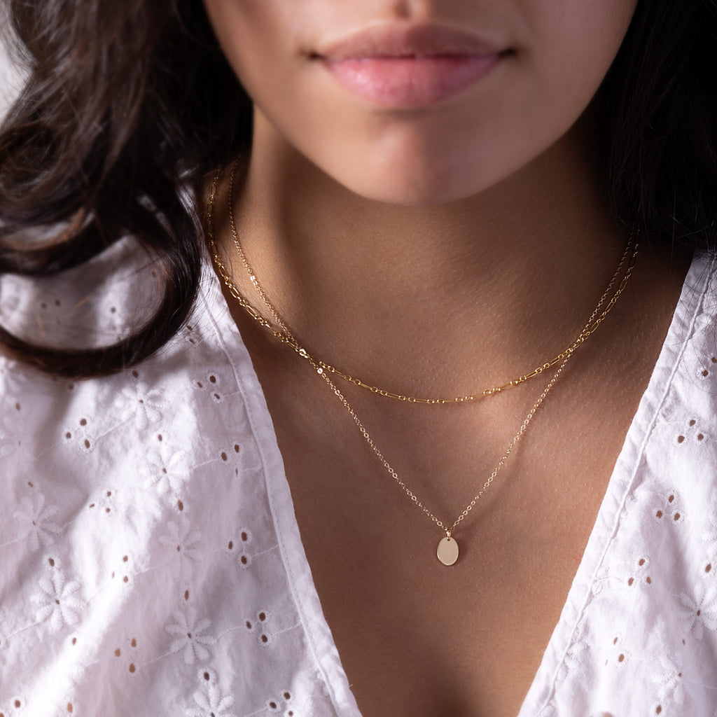a close up of a person wearing a necklace