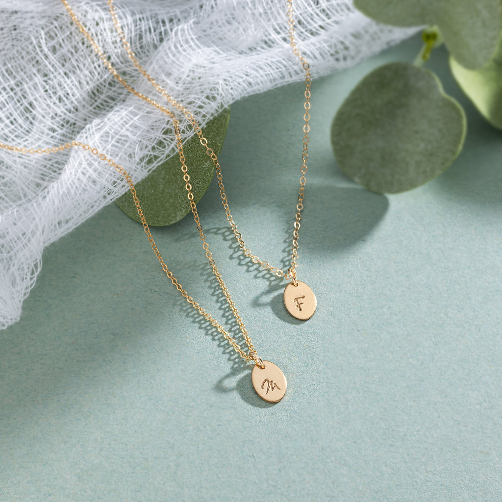 a couple of necklaces sitting on top of a table