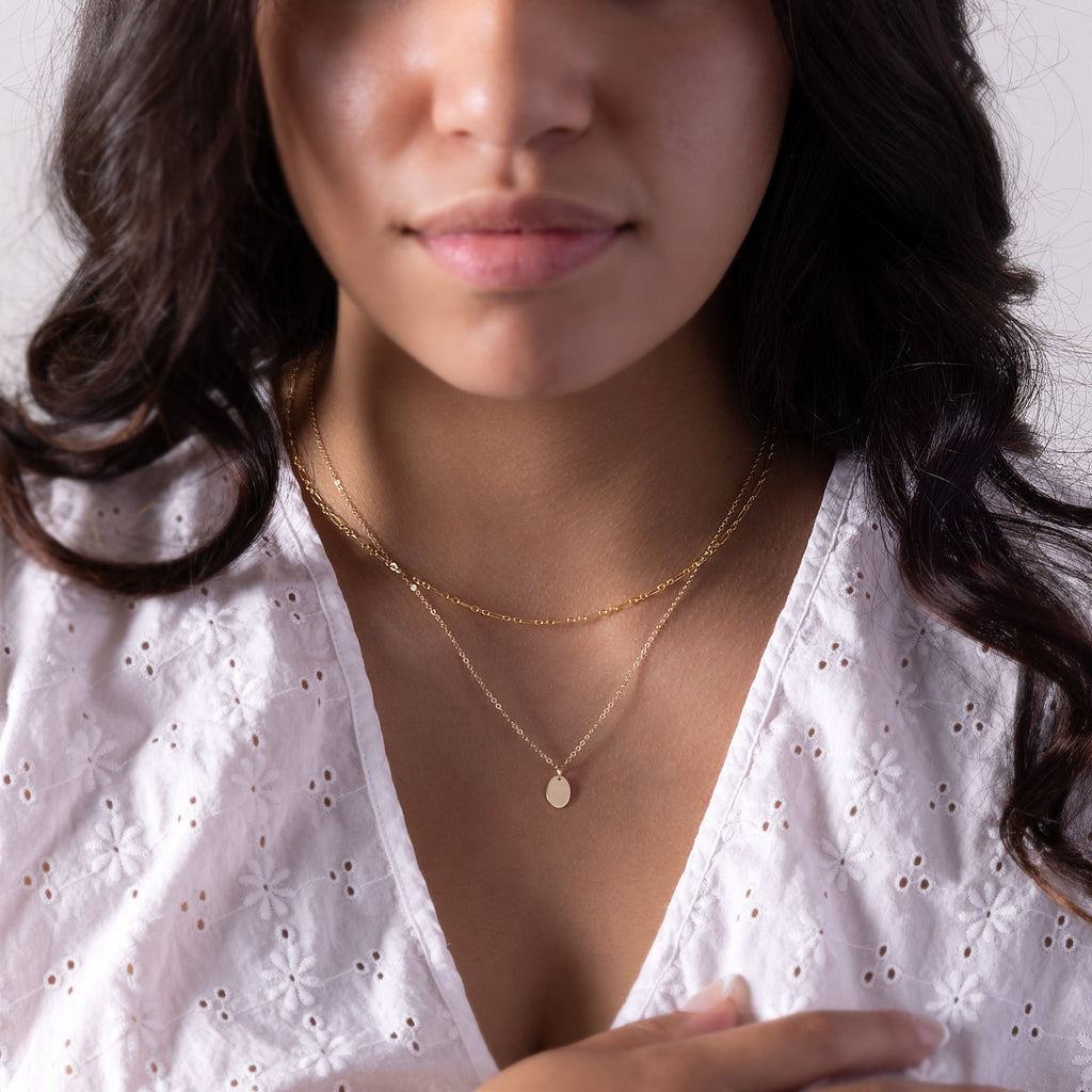 a close up of a person wearing a necklace