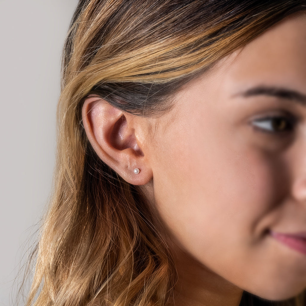a close up of a person wearing a pair of ear piercings