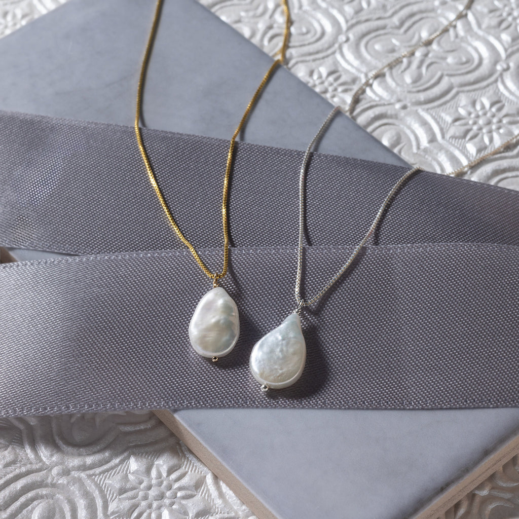 a couple of necklaces sitting on top of a table