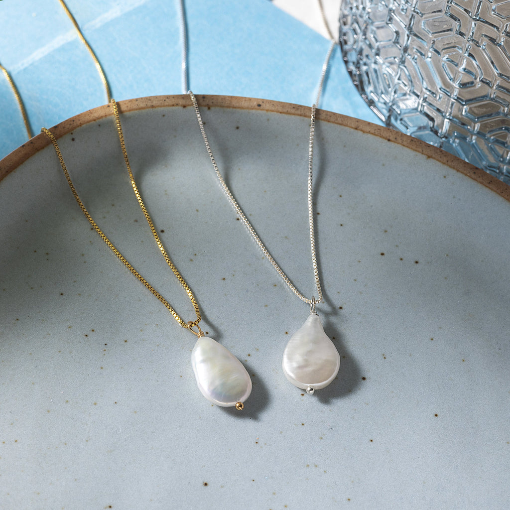 a couple of necklaces sitting on top of a plate