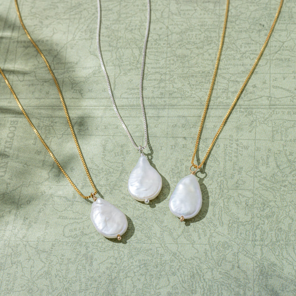 a group of three necklaces sitting on top of a table