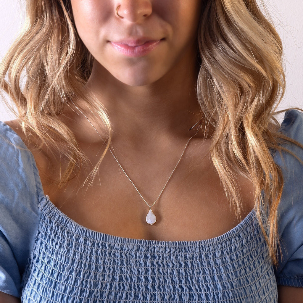 a close up of a person wearing a necklace