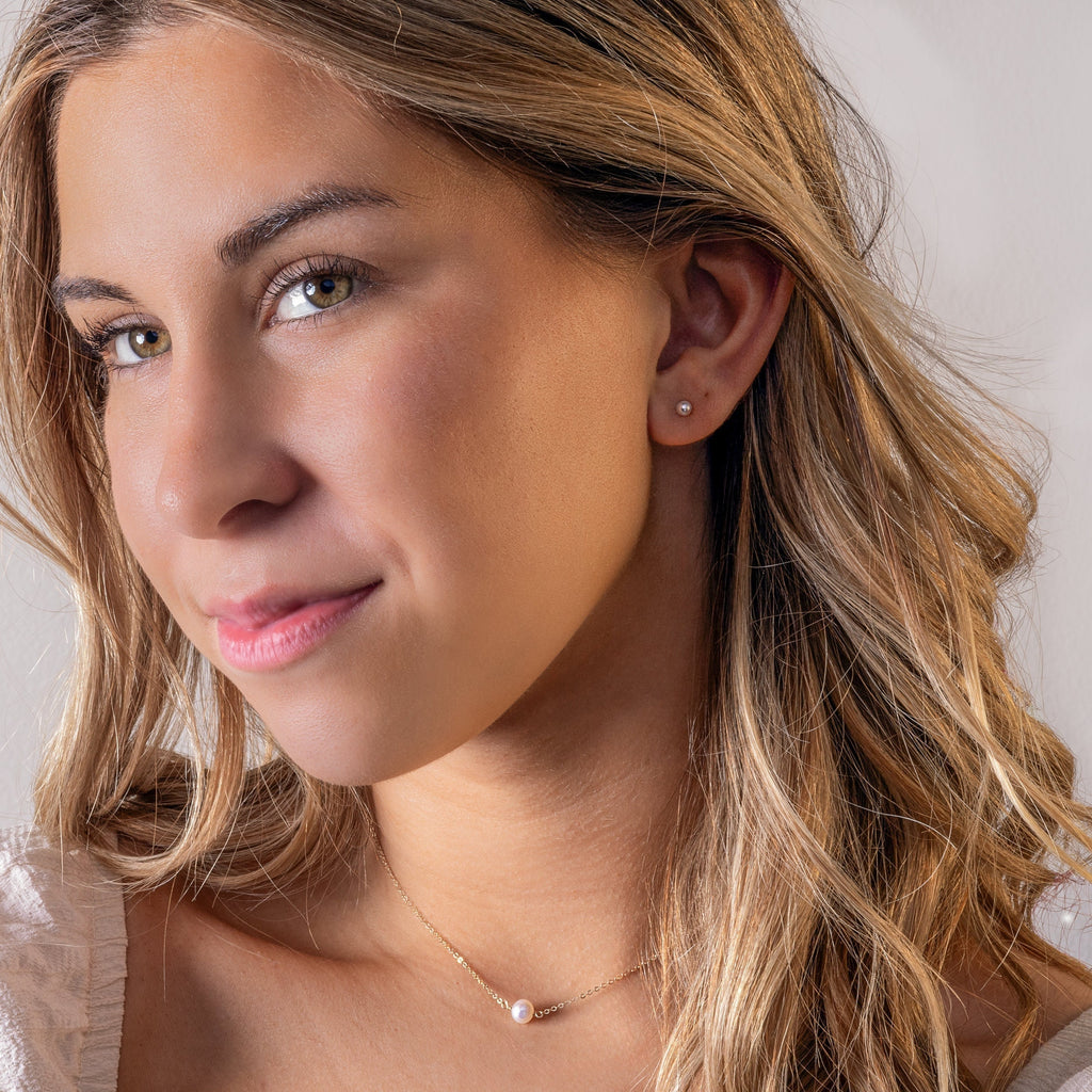 a close up of a person wearing a necklace