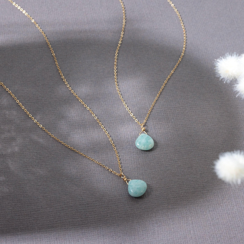 a couple of necklaces sitting on top of a table