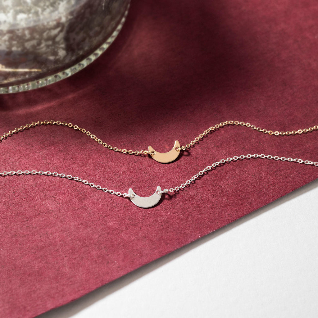 a necklace with a crescent and a crescent on it