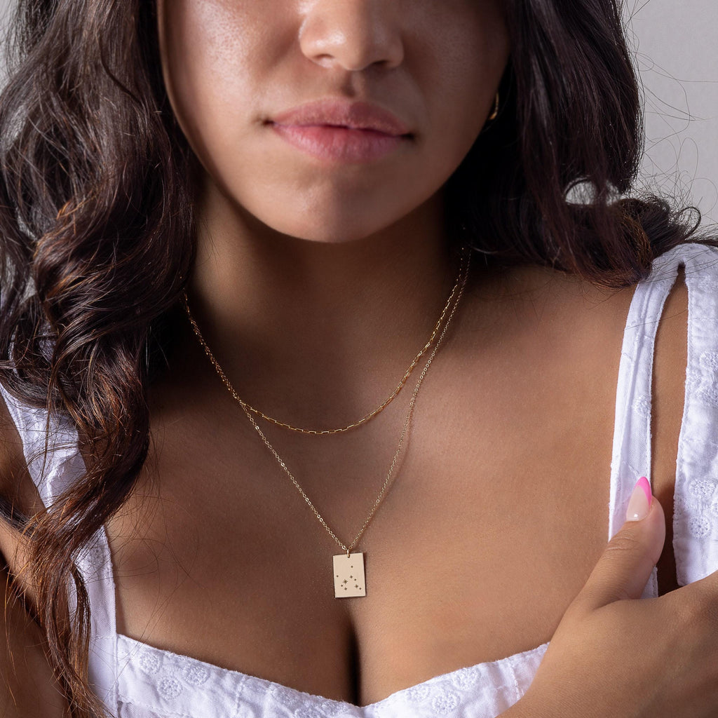 a close up of a person wearing a necklace