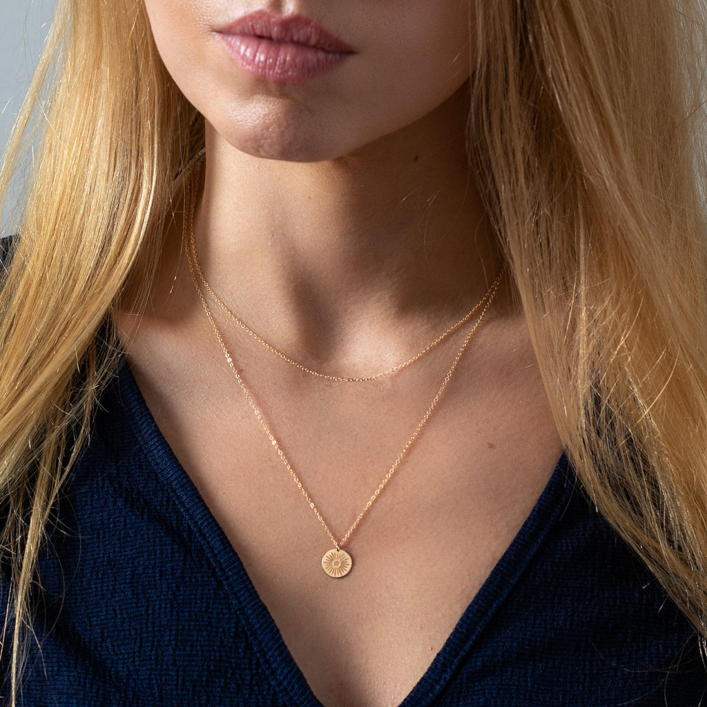 a close up of a woman wearing a necklace
