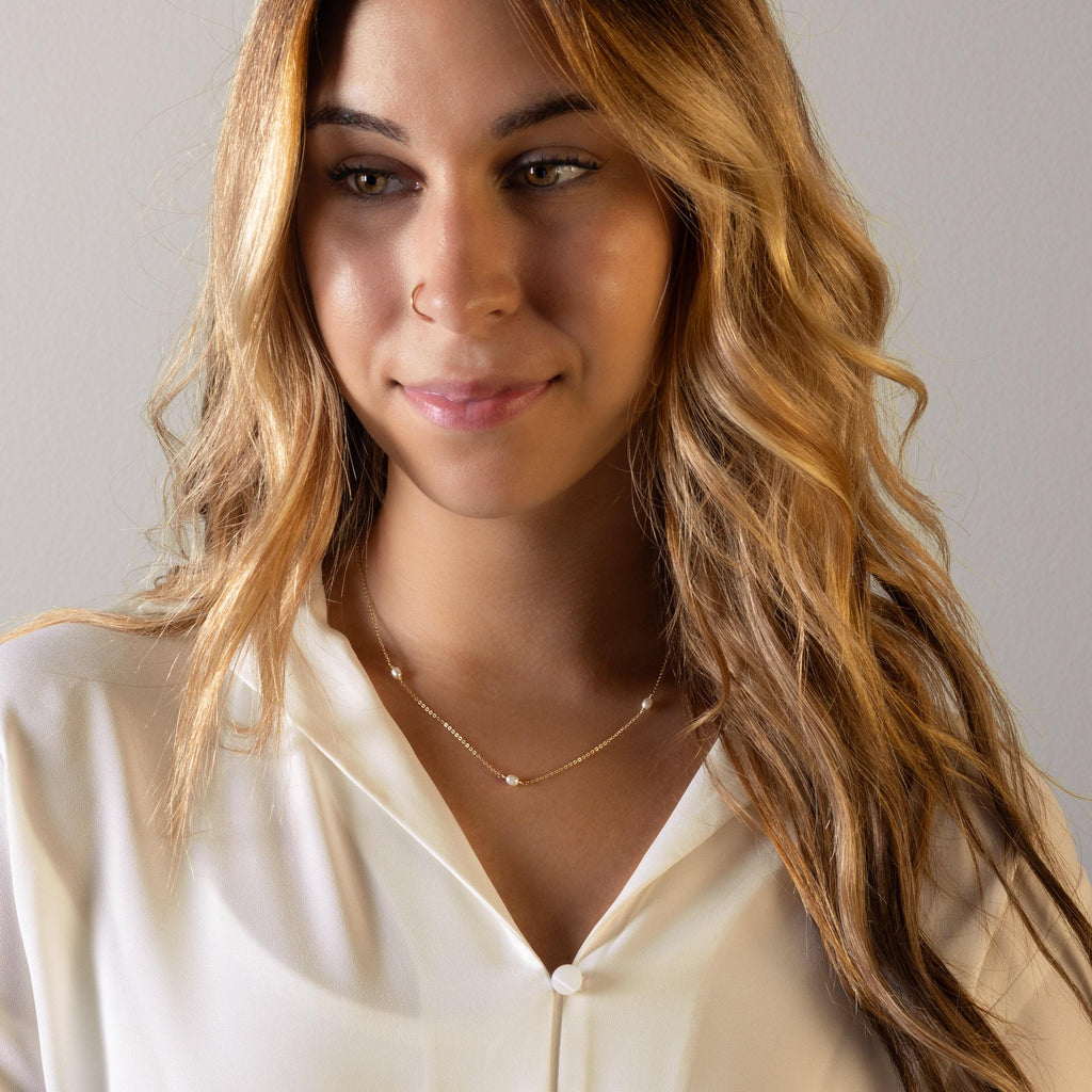 a woman with long hair wearing a white shirt