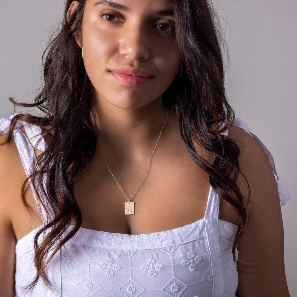 a woman in a white top is posing for a picture