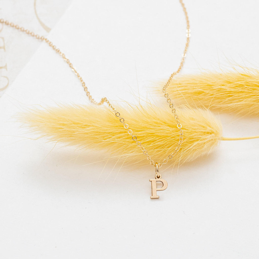 a necklace with a yellow feather on it