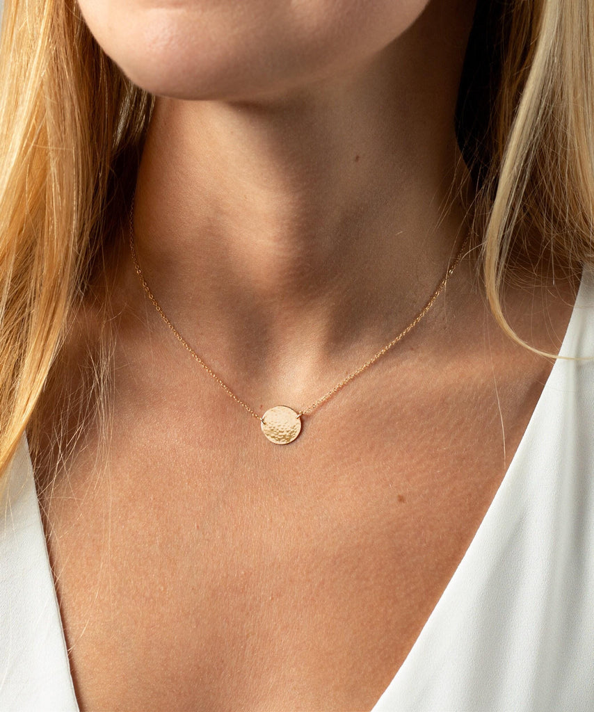 a close up of a woman wearing a necklace