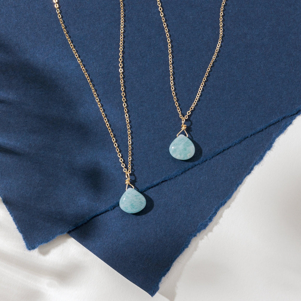 a close up of two necklaces on a piece of cloth
