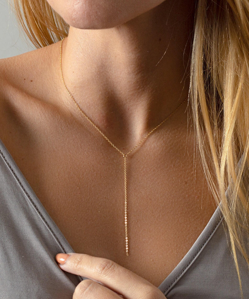 a close up of a woman wearing a necklace