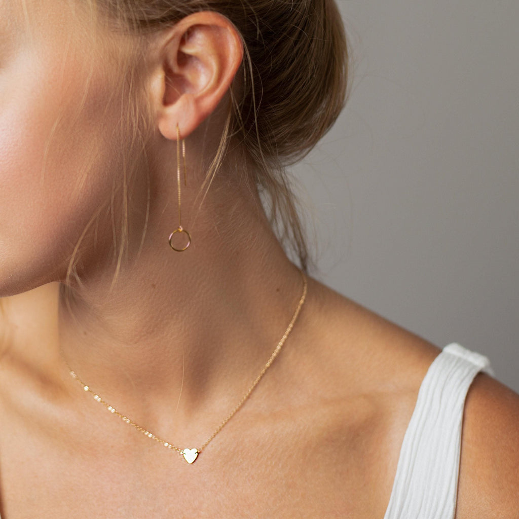 a close up of a woman wearing a necklace
