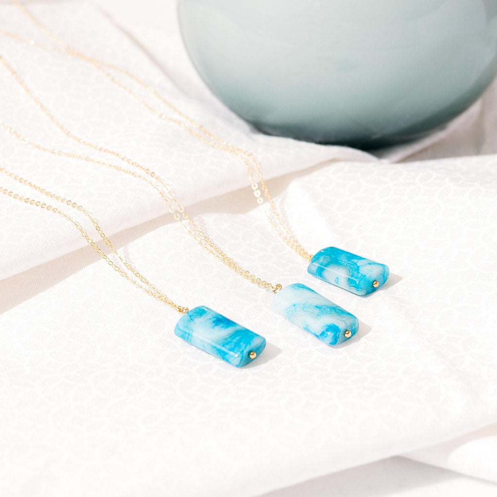 a couple of necklaces sitting on top of a table