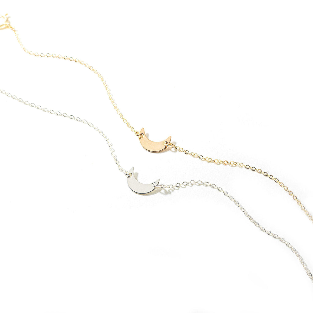 a necklace with a crescent and a star on it