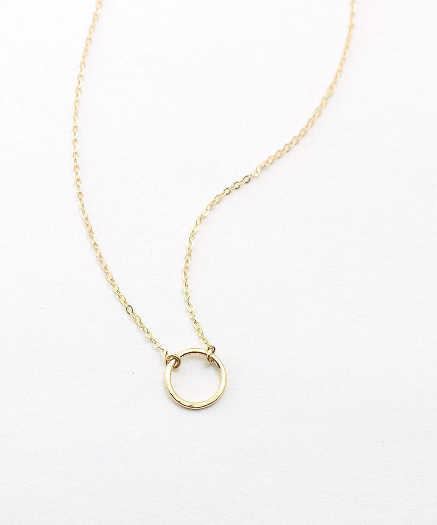 a gold necklace on a white background