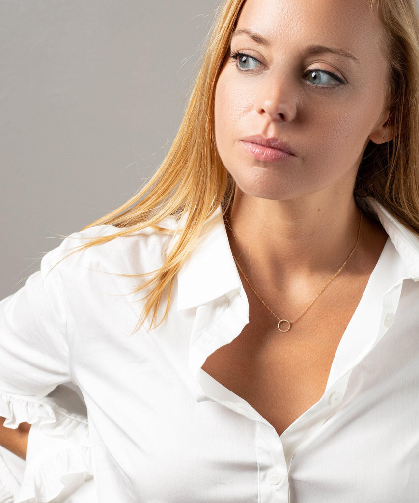 a woman in a white shirt posing for a picture