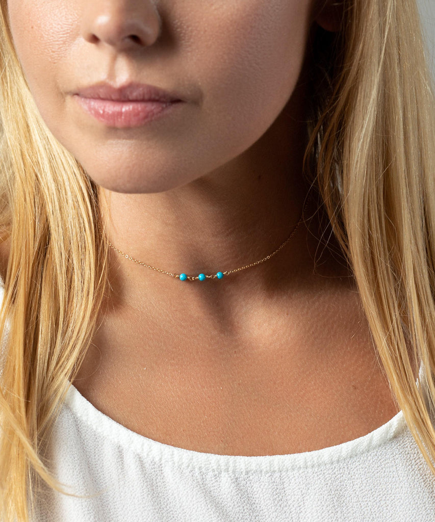 a close up of a woman wearing a necklace