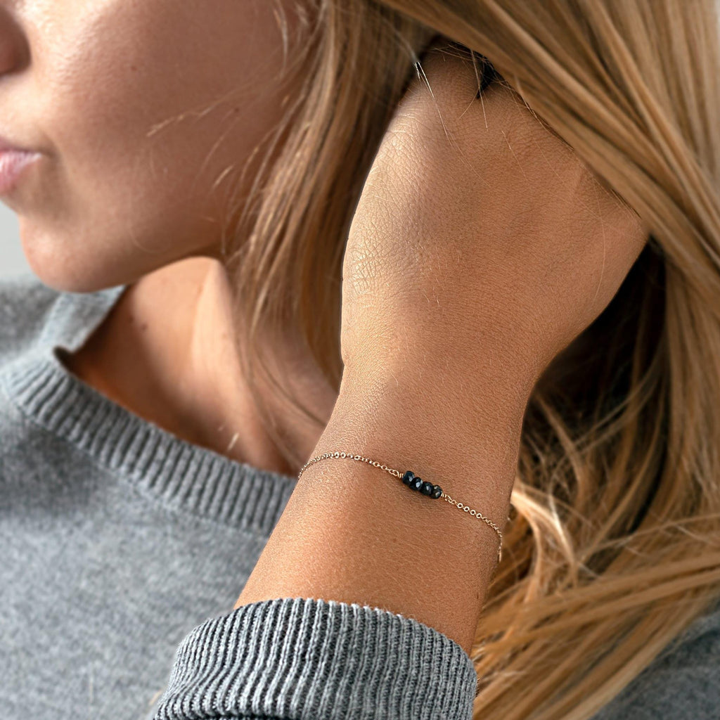 a close up of a woman wearing a bracelet
