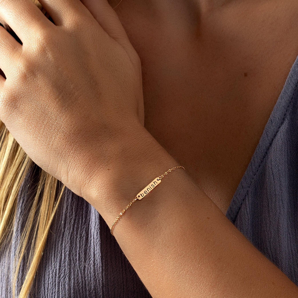 a close up of a person wearing a gold bracelet