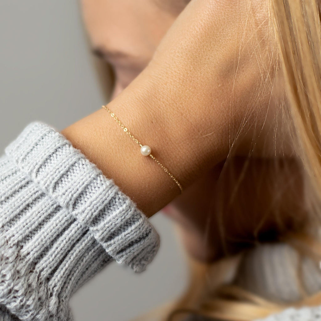 a close up of a person wearing a bracelet