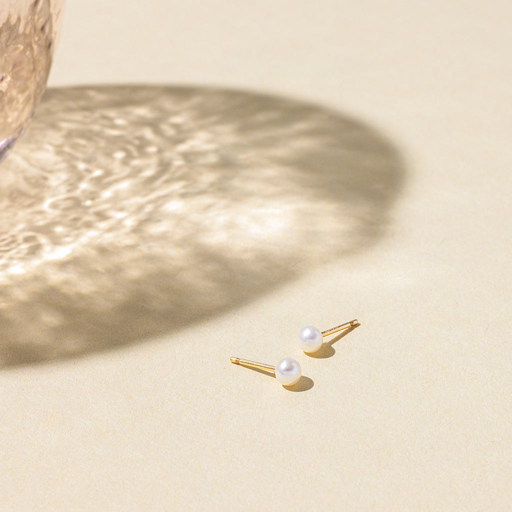 a pair of earrings sitting on top of a table