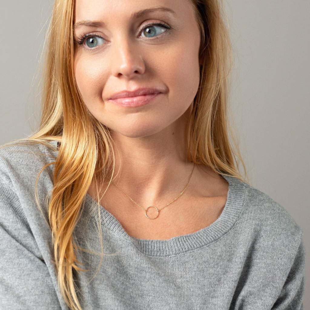 a beautiful blonde woman with blue eyes posing for a picture