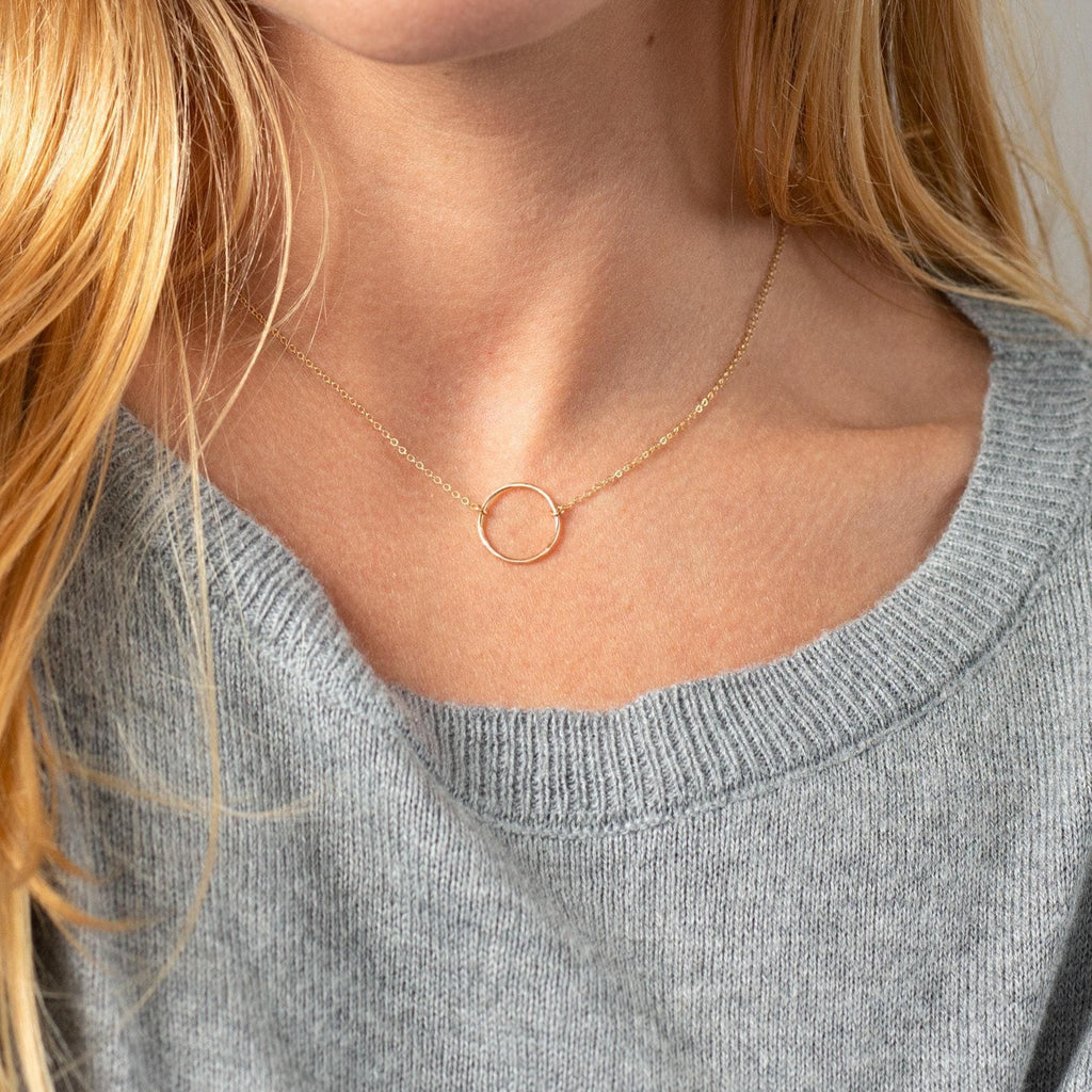 a close up of a woman wearing a necklace