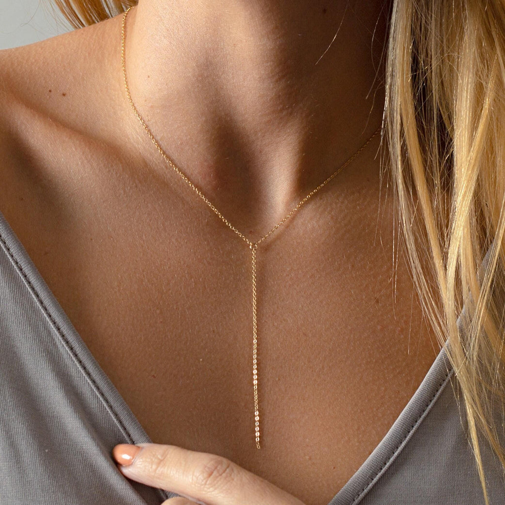 a close up of a woman wearing a necklace