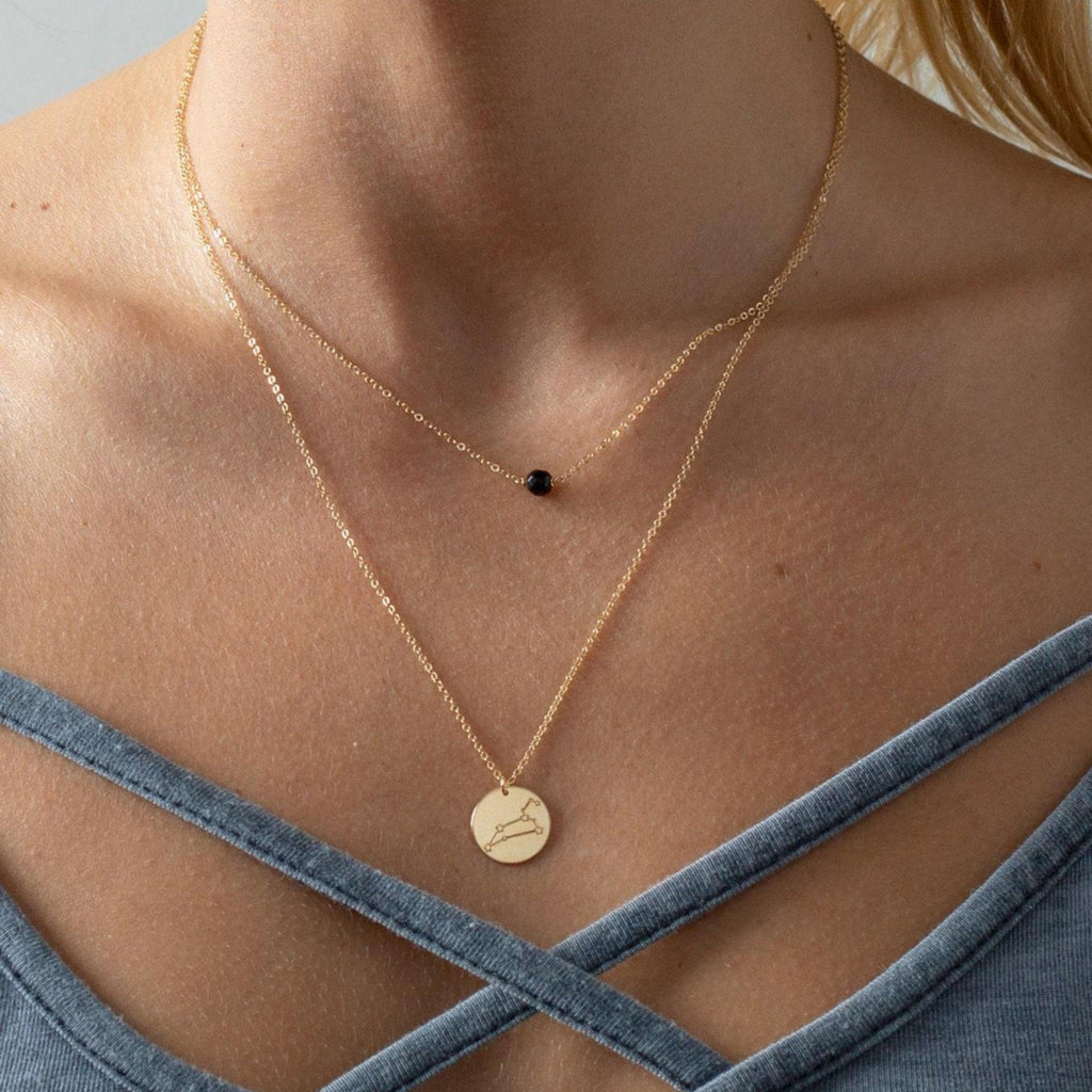 a close up of a person wearing a necklace