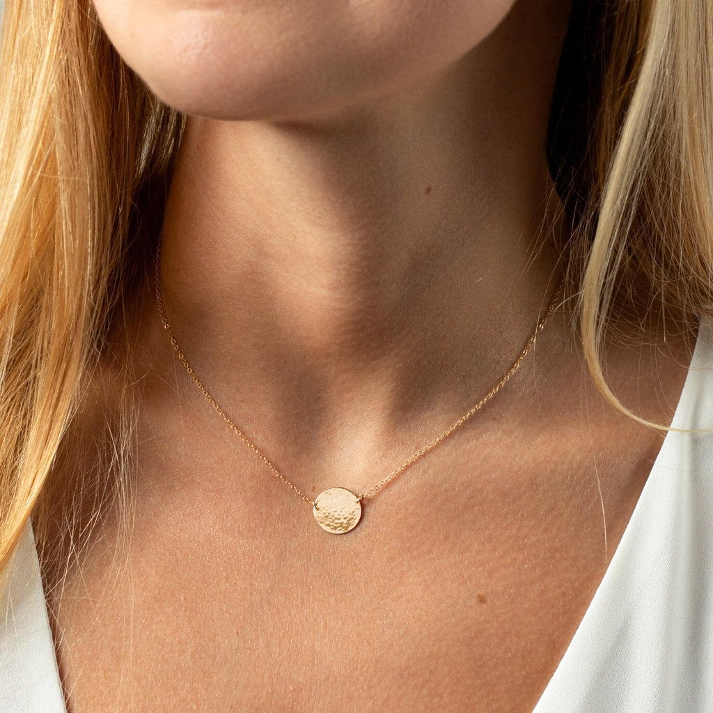 a close up of a woman wearing a necklace